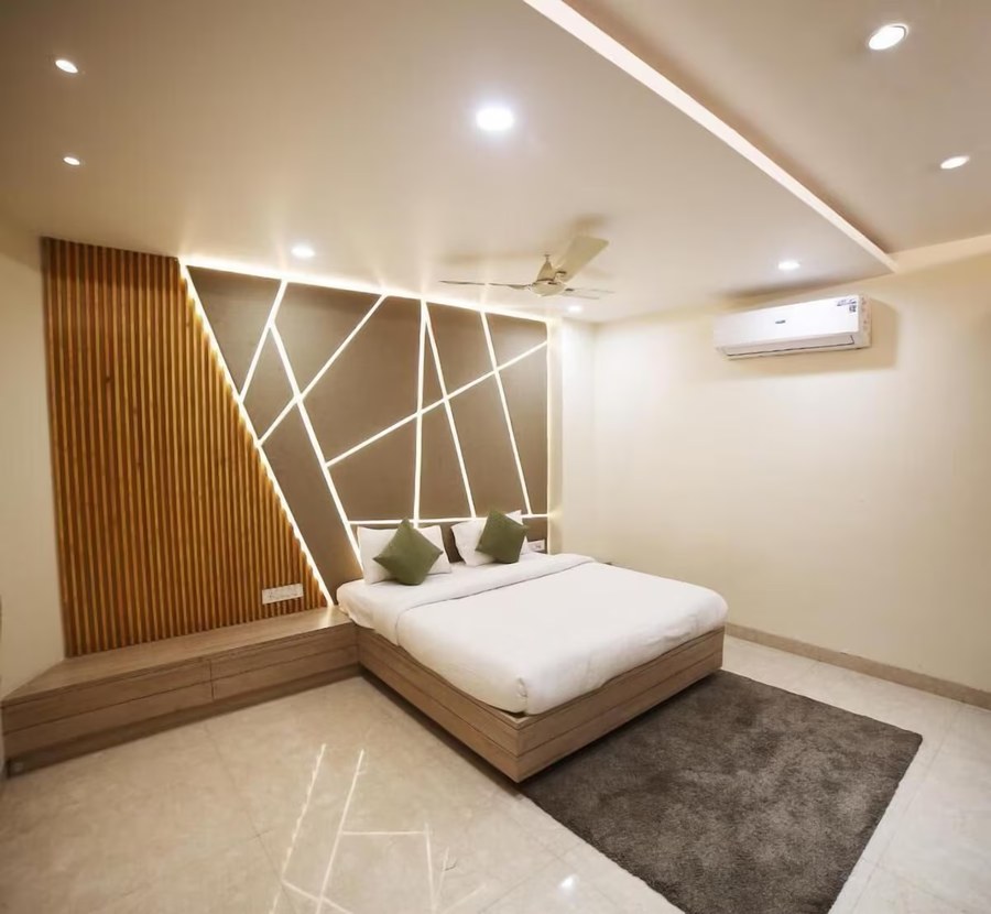 Guest room with feature headboard wall at Hotel Avantika, Bhopal