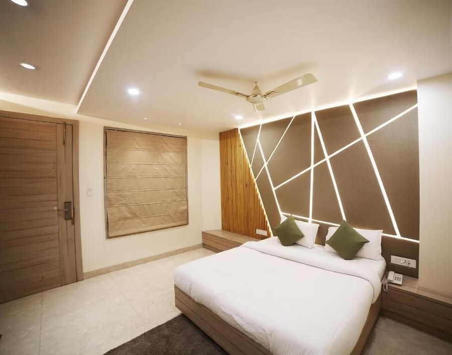Guest room with bed and feature lighting wall at Hotel Avantika, Bhopal
